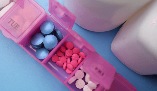 close up of medical pills in a pill box on table