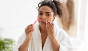 Woman Shaving Moustache Removing Facial Upper Lip Hair In Bathroom